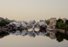 JR Conjures a Mountainous Illusion Out of the Pont Neuf in Paris